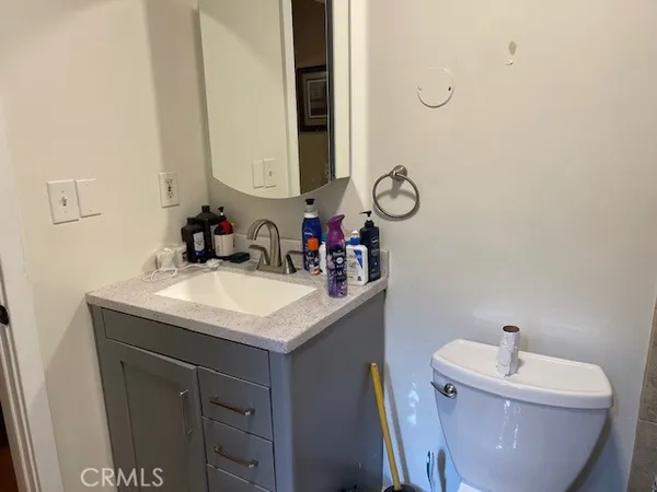 a bathroom with a sink vanity mirror and toilet