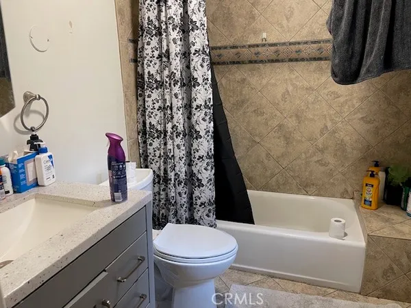a bathroom with a granite countertop sink toilet and bathtub