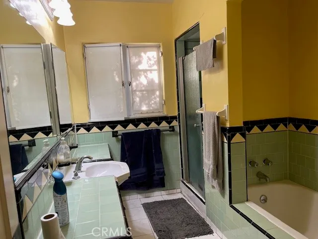 a bathroom with a shower and a sink