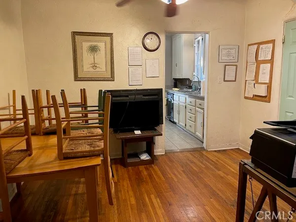 a living room with stainless steel appliances kitchen island granite countertop furniture and a flat screen tv