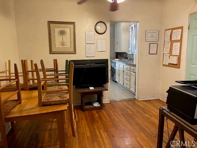 a living room with stainless steel appliances kitchen island granite countertop furniture and a flat screen tv