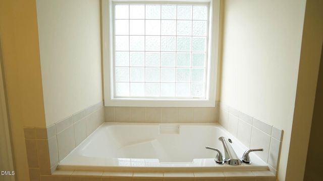 a bath tub sitting next to a window