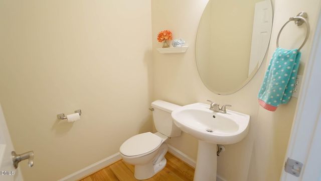 a bathroom with a sink toilet and a mirror