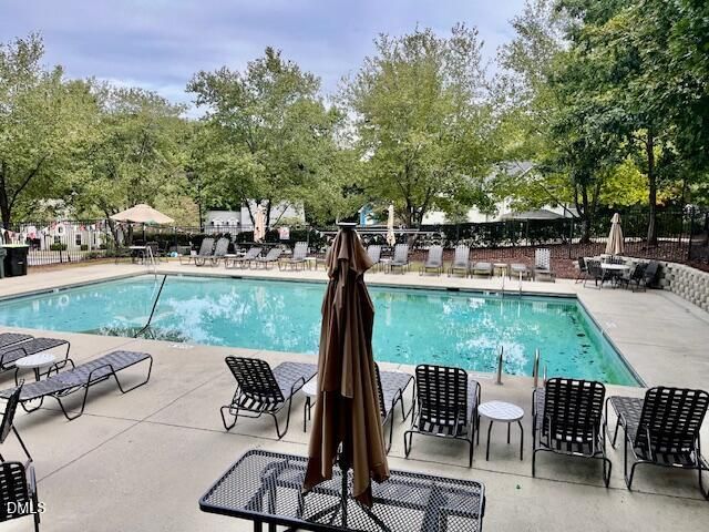 a view of a patio with a table chairs and a backyard