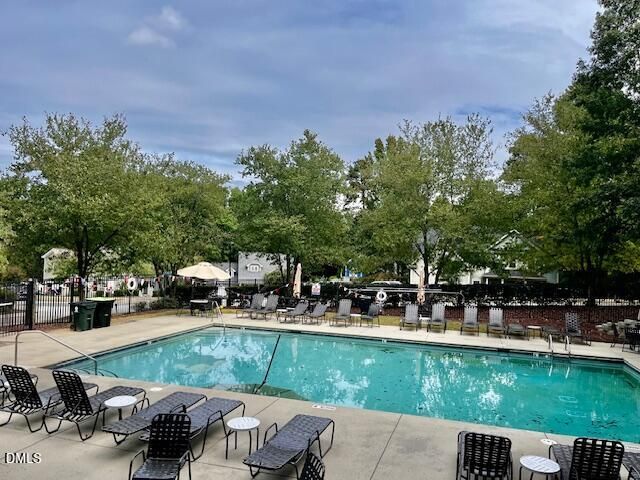 a view of a lake with a bench and trees around