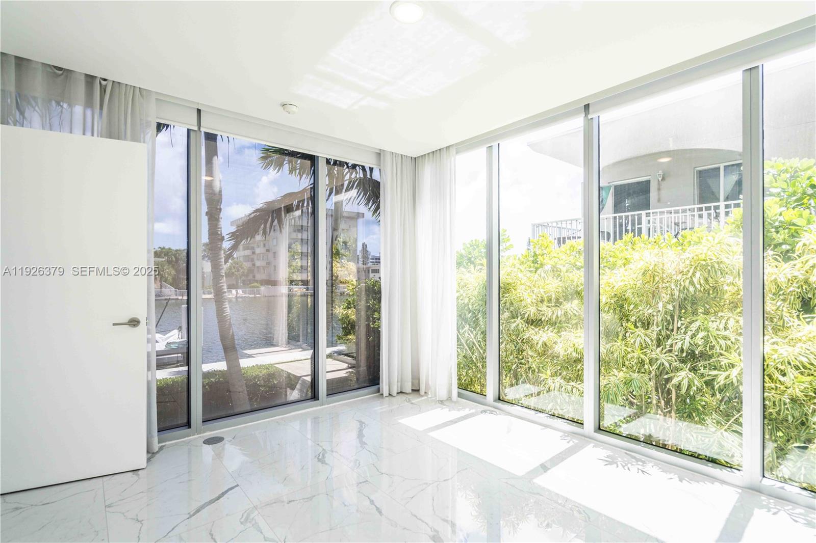 8425 Crespi Boulevard, Unit TH3 Miami Beach, FL 33141 - Photo 12 of 28 a view of a room with large windows
