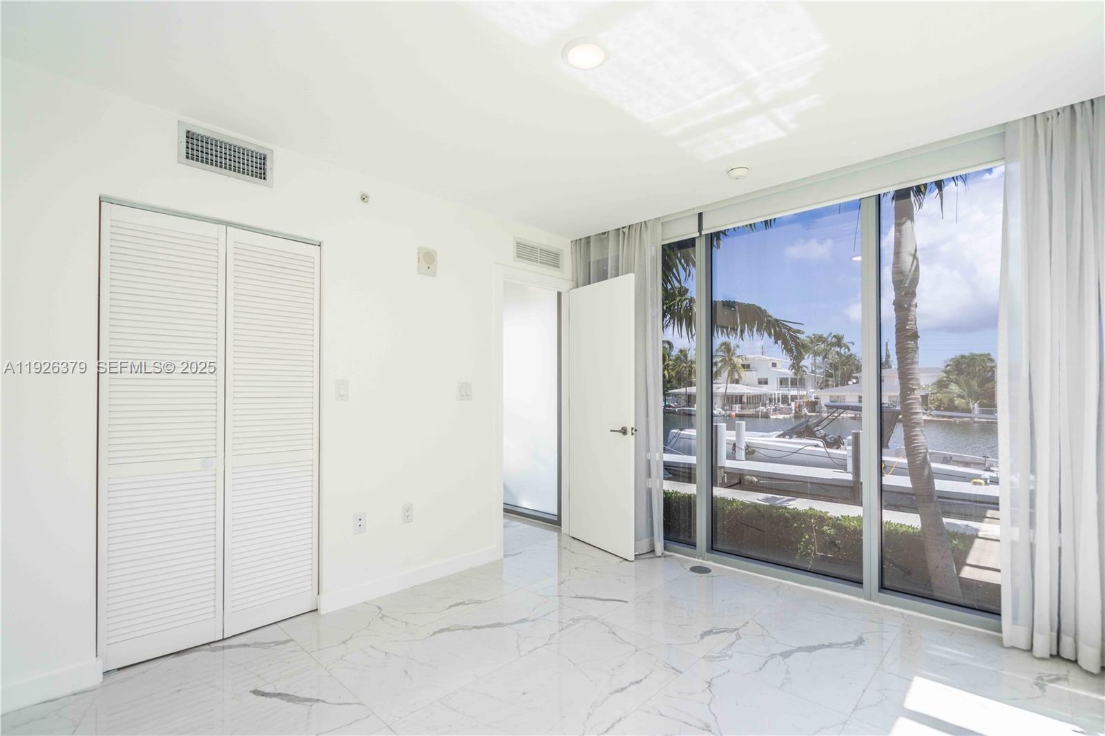 8425 Crespi Boulevard, Unit TH3 Miami Beach, FL 33141 - Photo 13 of 28 a view of an empty room and bathroom with a glass door