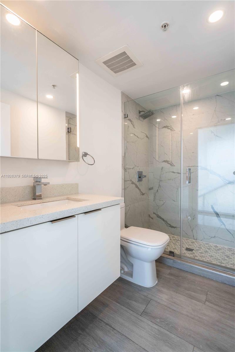 8425 Crespi Boulevard, Unit TH3 Miami Beach, FL 33141 - Photo 15 of 28 a bathroom with a sink a toilet and shower