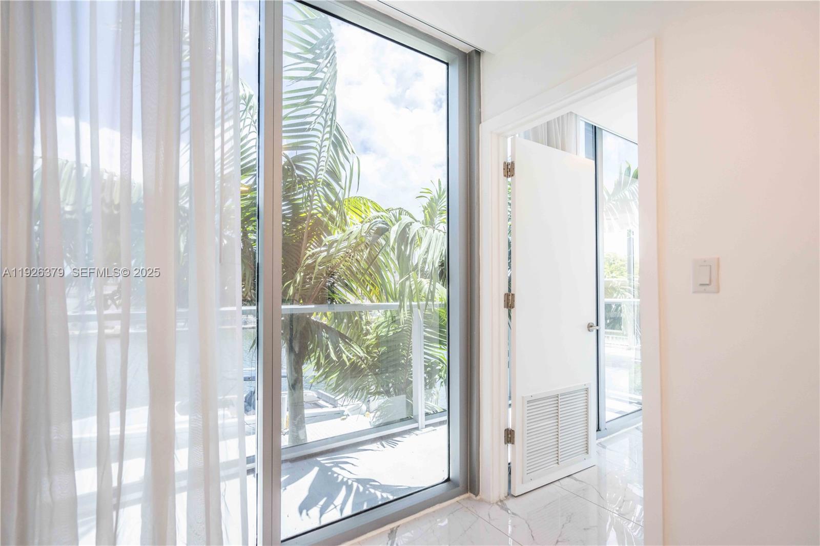 8425 Crespi Boulevard, Unit TH3 Miami Beach, FL 33141 - Photo 17 of 28 a view of an entryway with a glass door