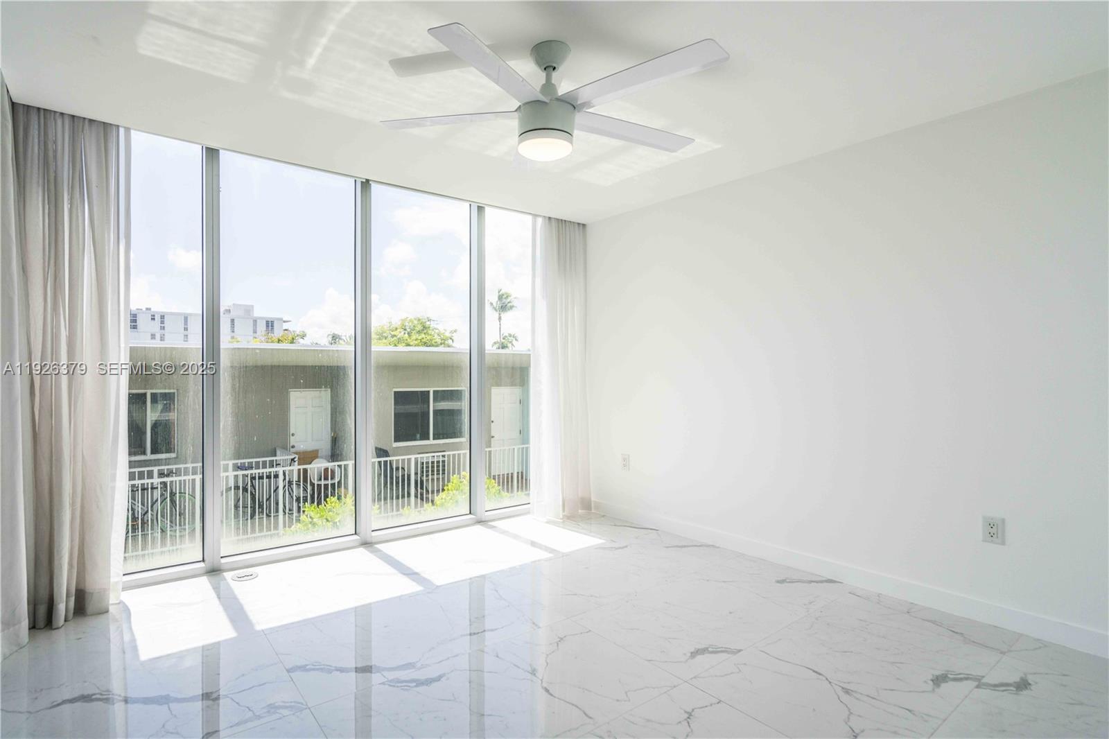 8425 Crespi Boulevard, Unit TH3 Miami Beach, FL 33141 - Photo 19 of 28 a view of an empty room with a window