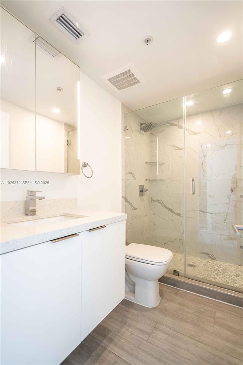 8425 Crespi Boulevard, Unit TH3 Miami Beach, FL 33141 - Photo 23 of 28 a bathroom with a sink a toilet and shower