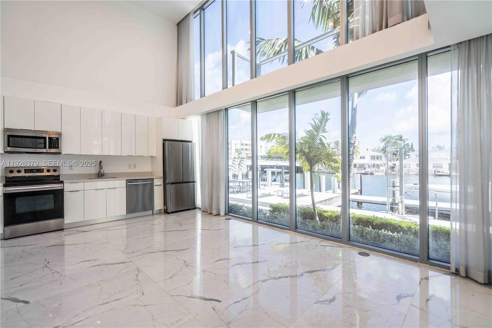 8425 Crespi Boulevard, Unit TH3 Miami Beach, FL 33141 - Photo 9 of 28 a open kitchen with stainless steel appliances granite countertop a stove top oven a sink and cabinets