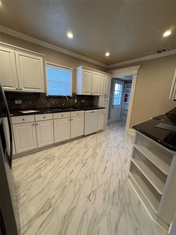 4558 Roland Avenue, Unit B Highland Park, TX 75219 - Photo 5 of 10 a large kitchen with stainless steel appliances granite countertop a stove and a sink