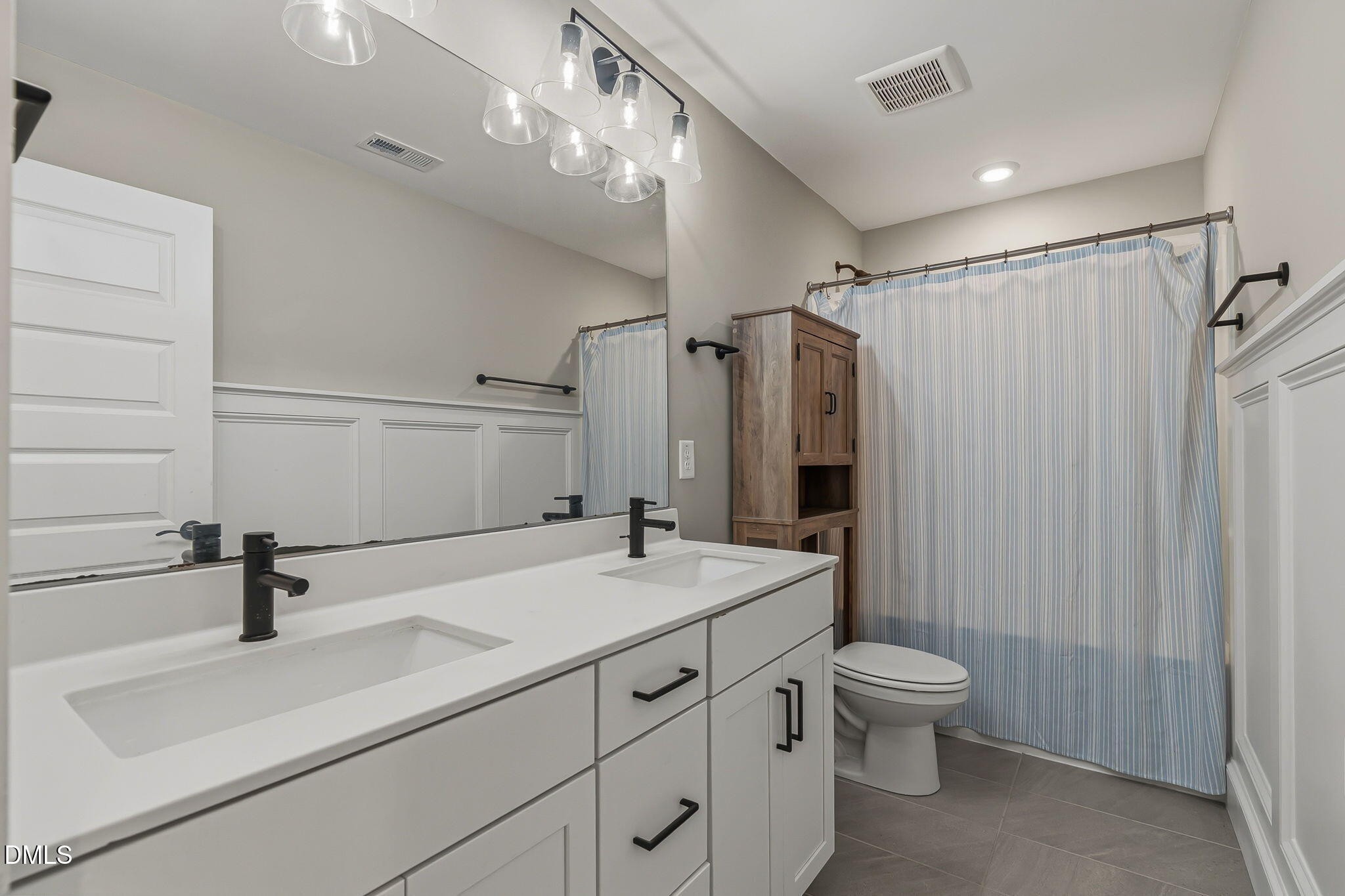 438 Diversity Way Raleigh, NC 27610 - Photo 20 of 33 a bathroom with a sink a toilet a mirror and shower