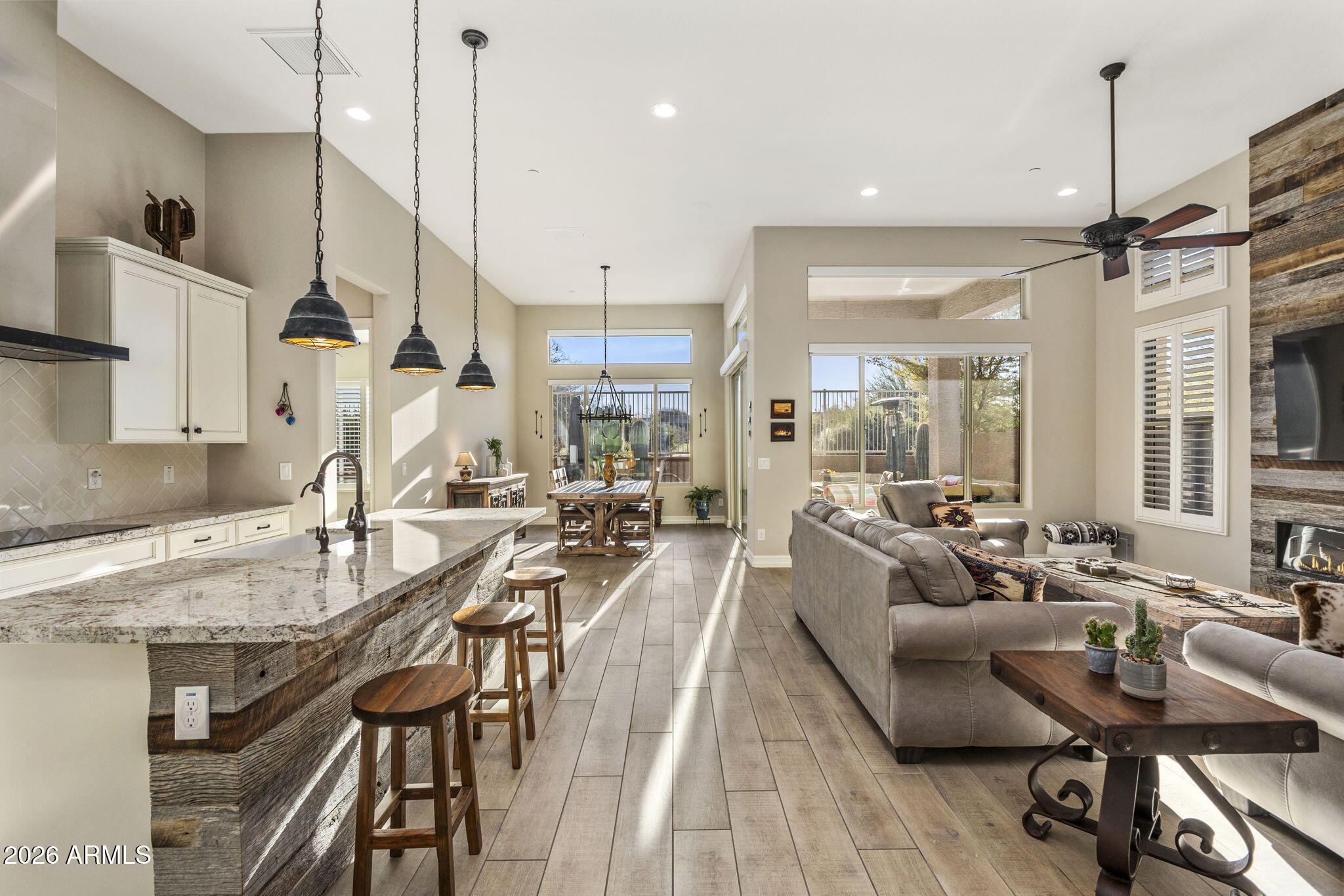 18785 East Blue Sky Drive Rio Verde, AZ 85263 - Photo 3 of 23 a large kitchen with sink cabinets and a wooden floor