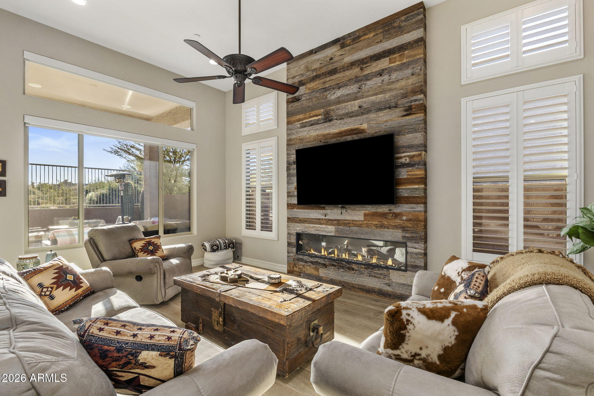 18785 East Blue Sky Drive Rio Verde, AZ 85263 - Photo 9 of 23 a living room with furniture a flat screen tv and a fireplace