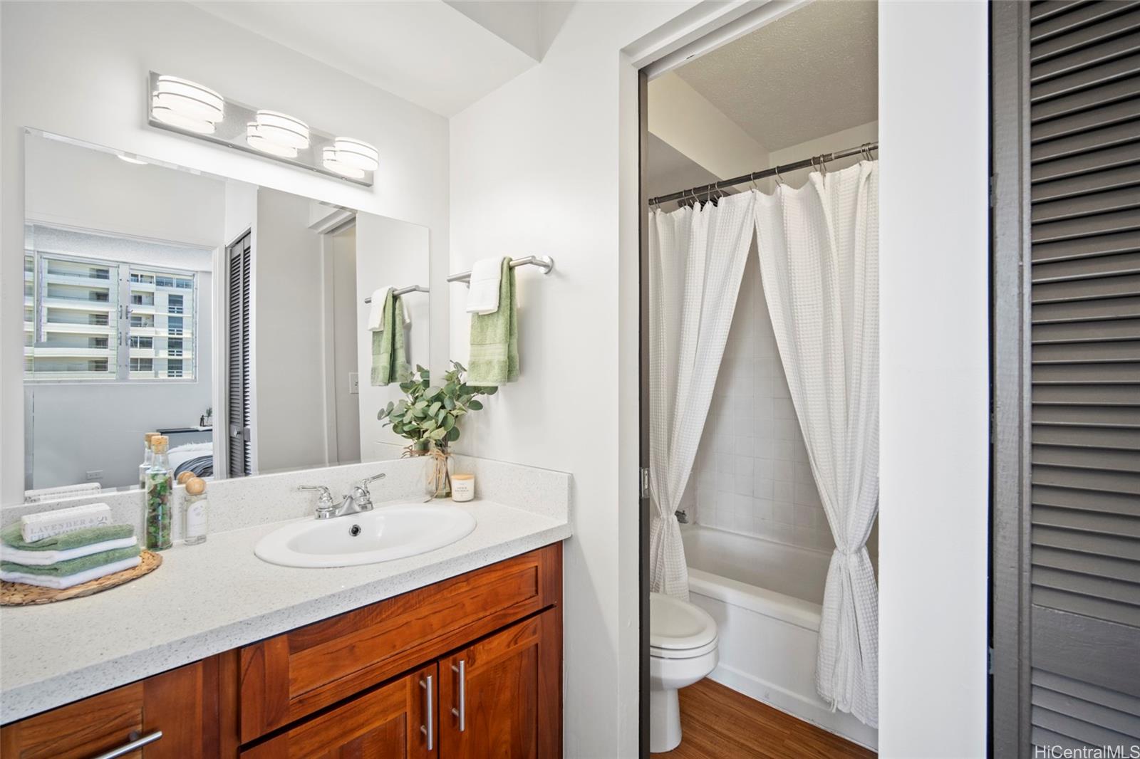 1624 Dole Street, Unit 801 Honolulu, HI 96822 - Photo 13 of 20 a bathroom with a double vanity sink and a mirror