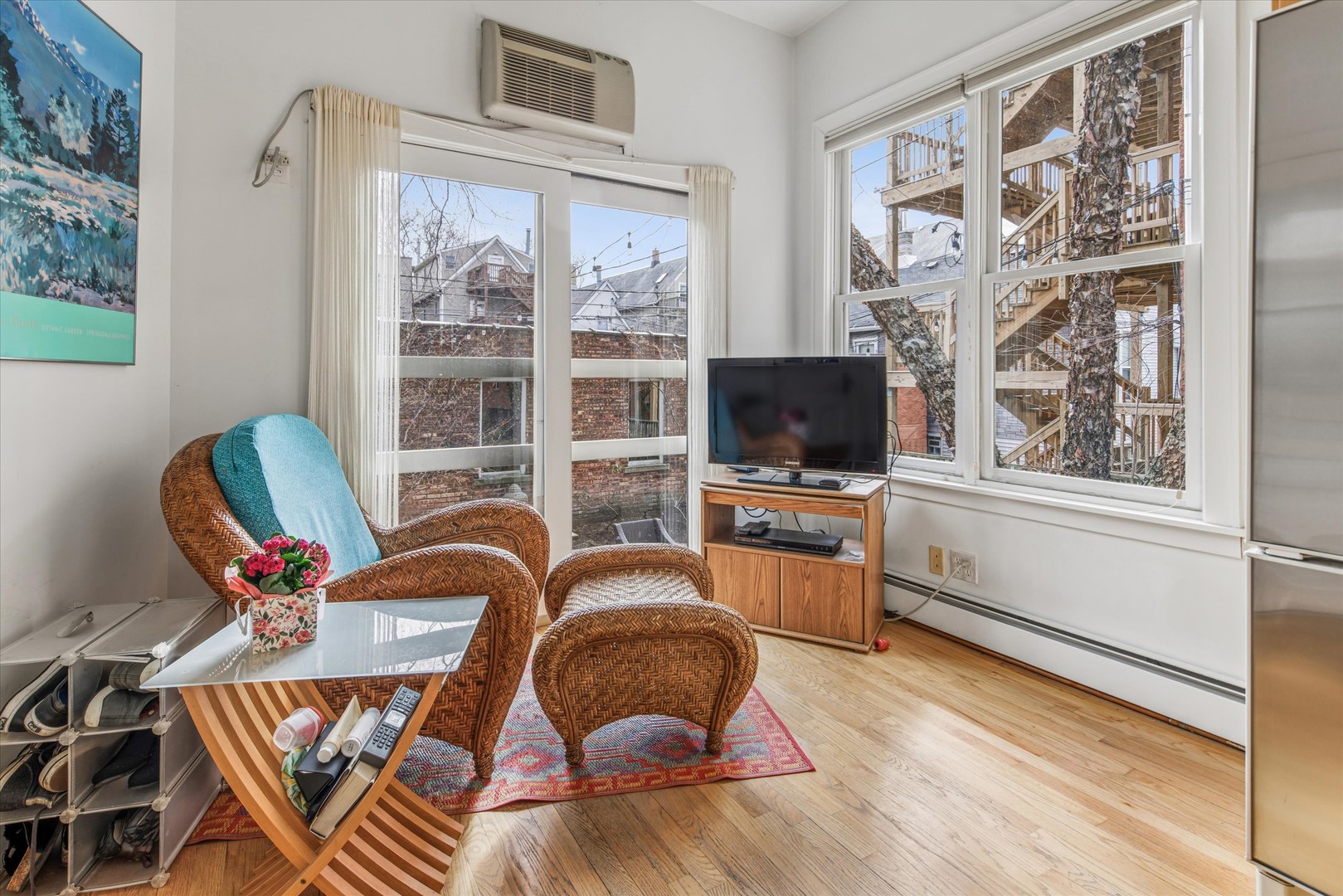 3135 North Seminary Avenue, Unit 1 Chicago, IL 60657 - Photo 8 of 18 a workspace with furniture a flat screen tv and a window