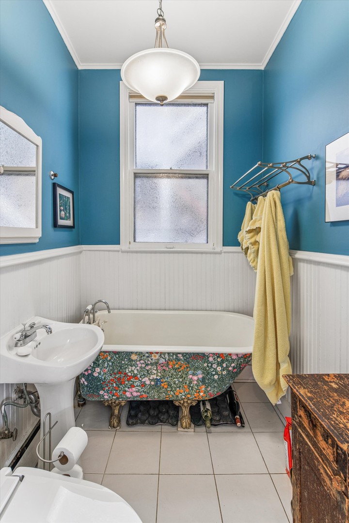 3135 North Seminary Avenue, Unit 1 Chicago, IL 60657 - Photo 9 of 18 a bedroom with a bed and a window
