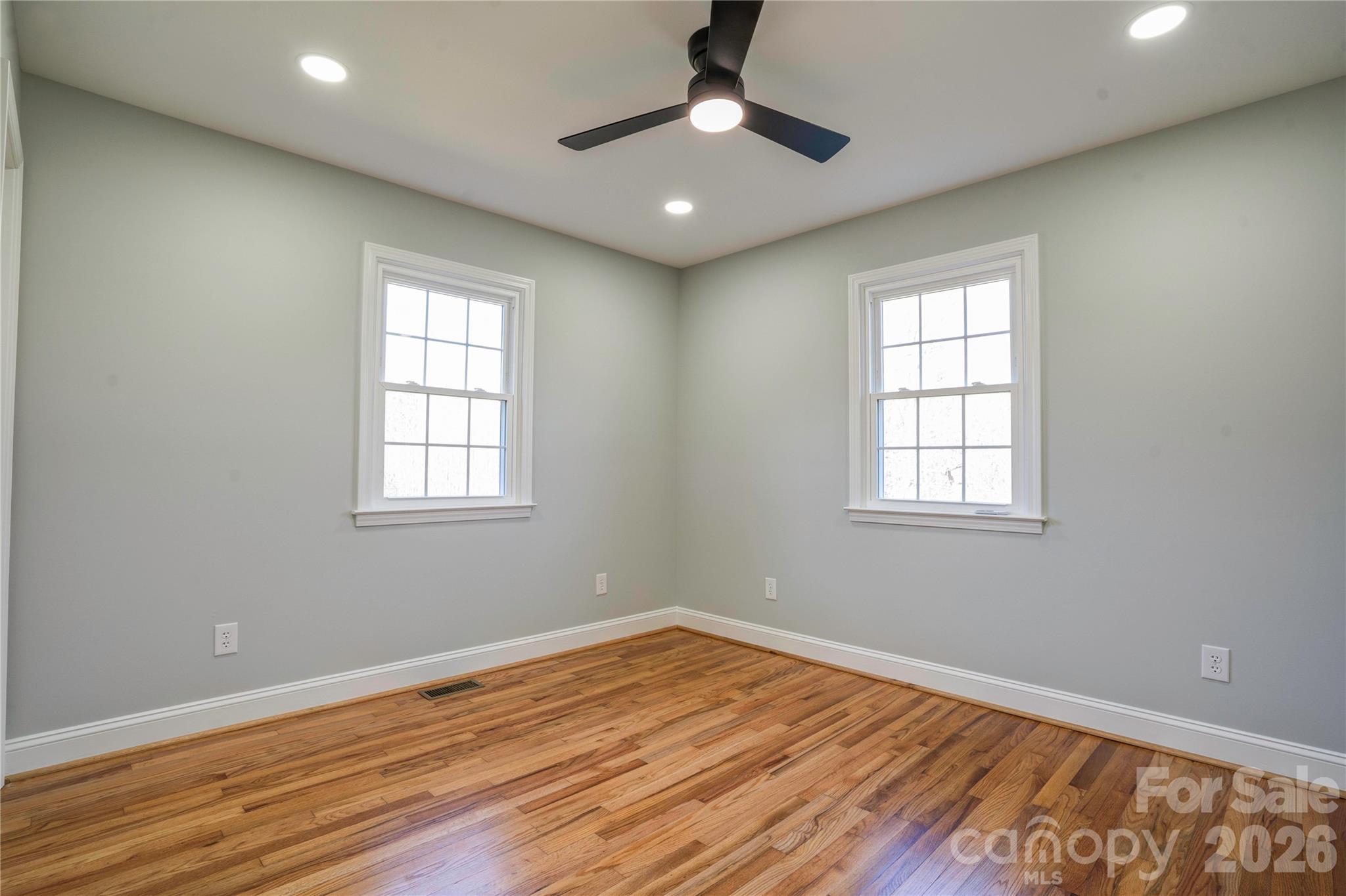 2822 Bettis Road Grover, NC 28073 - Photo 13 of 32 a view of empty room with wooden floor and fan