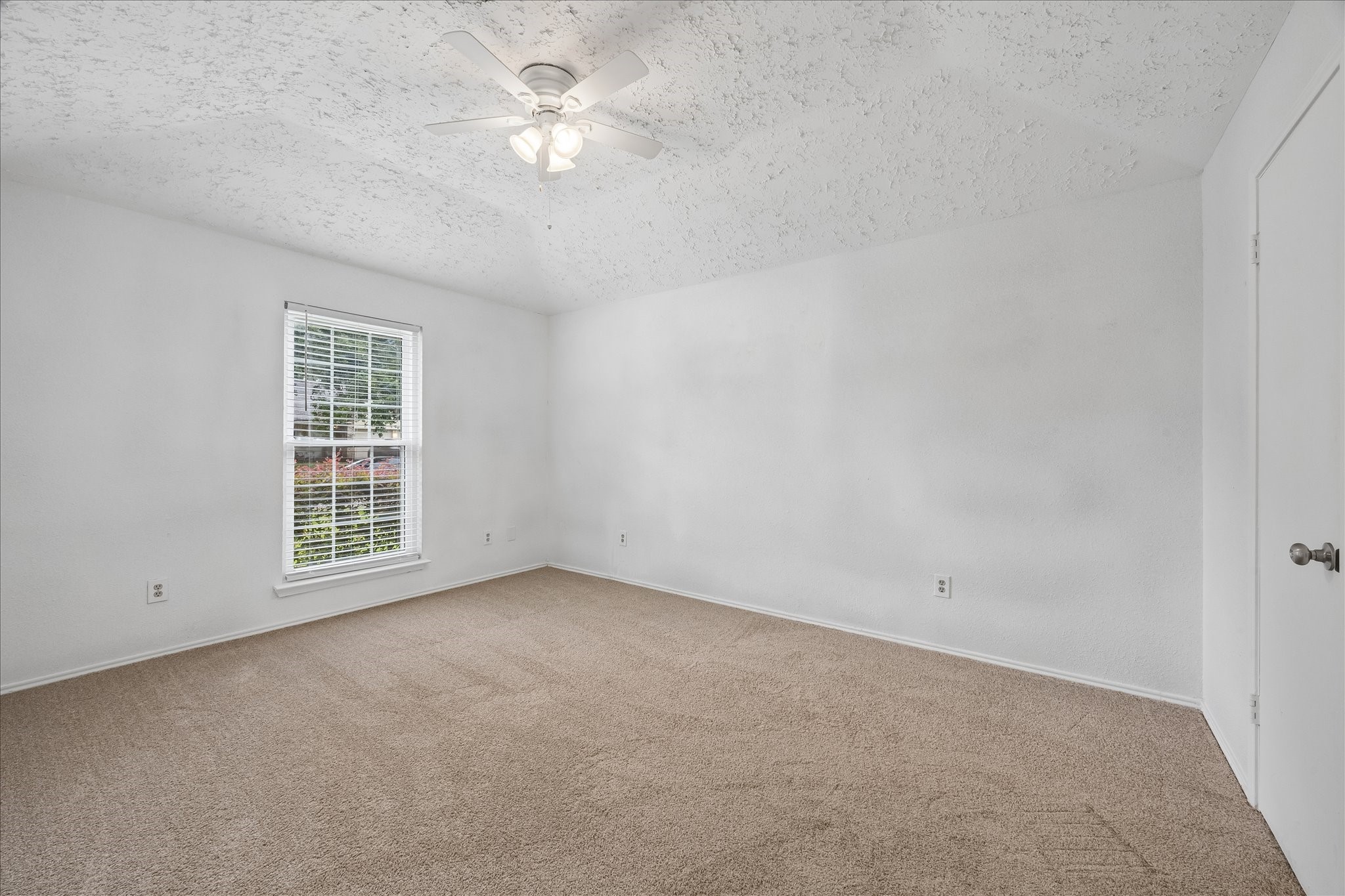 16715 Benchmark Drive Houston, TX 77053 - Photo 10 of 14 an empty room with a window and a ceiling fan