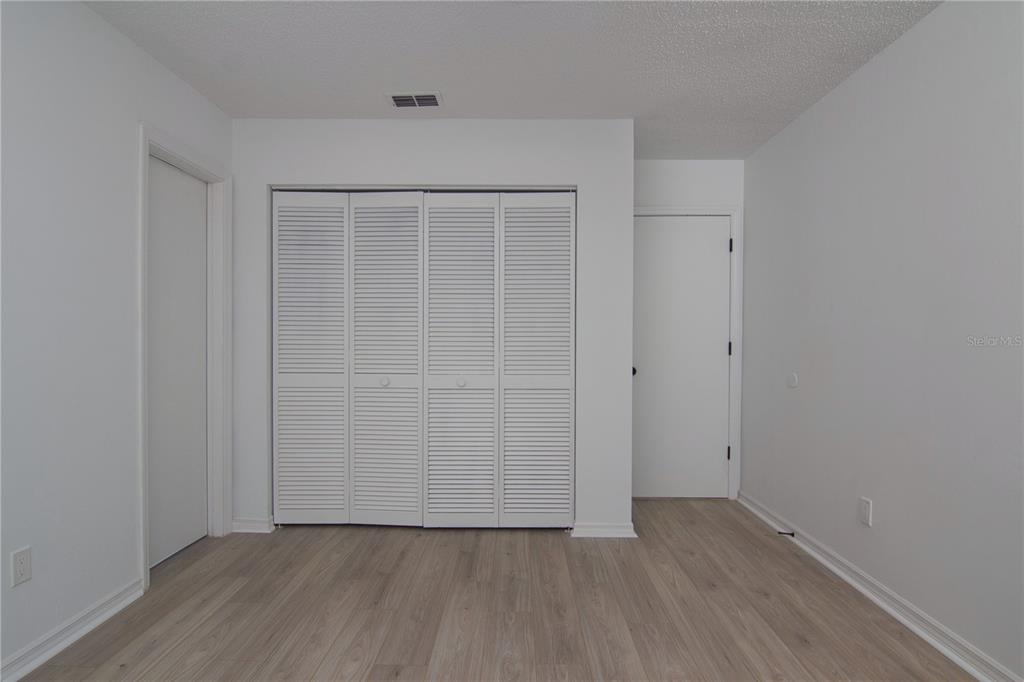 1831 Foxhall Circle Kissimmee, FL 34741 - Photo 12 of 16 an empty room with wooden floor