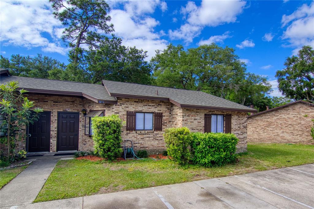 1831 Foxhall Circle Kissimmee, FL 34741 - Photo 2 of 16 a view of a house with a yard and potted plants
