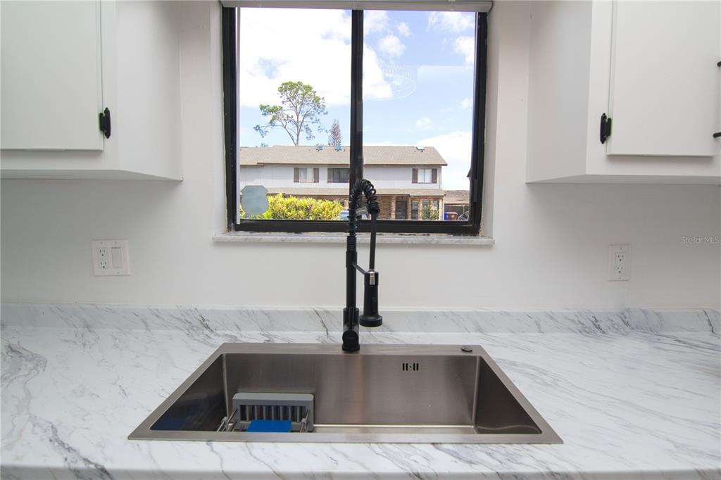 1831 Foxhall Circle Kissimmee, FL 34741 - Photo 4 of 16 a kitchen with sink and window