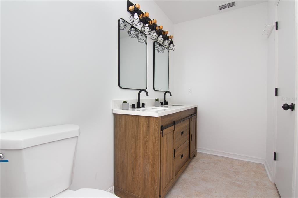 1831 Foxhall Circle Kissimmee, FL 34741 - Photo 10 of 16 a bathroom with a sink and a mirror