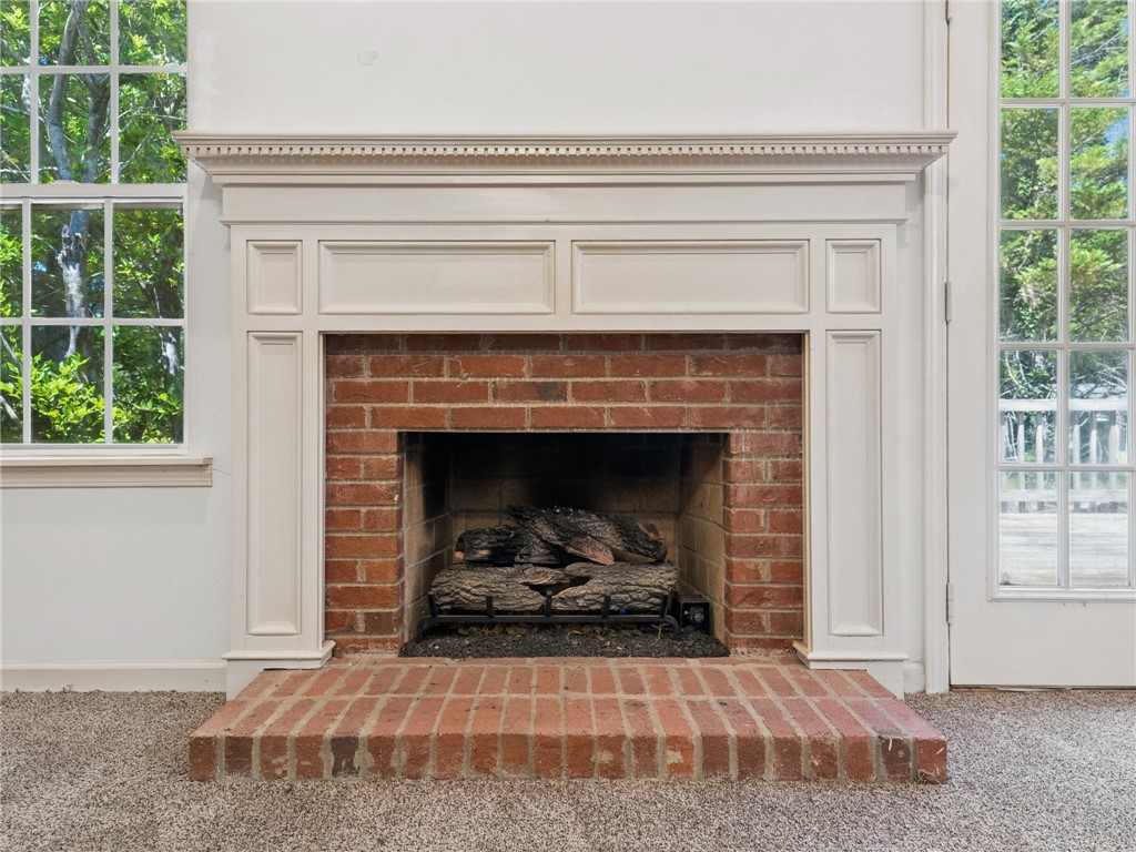 101 Woodbridge Circle Anderson, SC 29621 - Photo 2 of 21 This living room features a classic brick fireplace with a detailed mantel, ideal for cozy evenings.