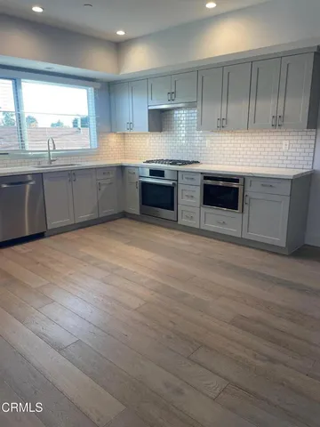 a bathroom with a toilet sink vanity and mirror