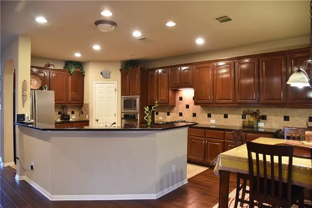 a kitchen with counter top space a sink and cabinets
