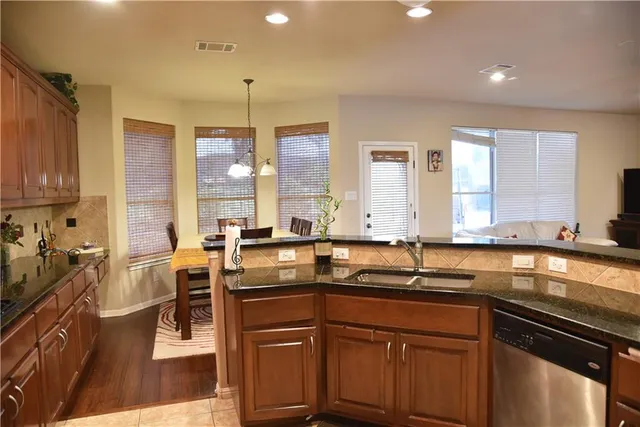 a kitchen with a sink stove and cabinets