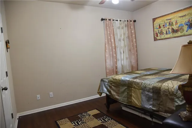 a bed sitting in a bedroom next to a window