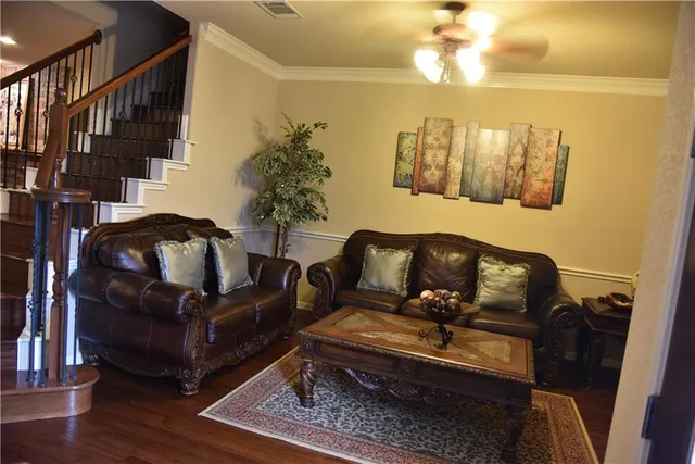 a living room with furniture and wooden floor