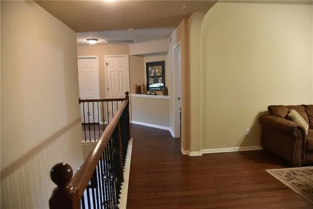 a view of entryway and hall with wooden floor