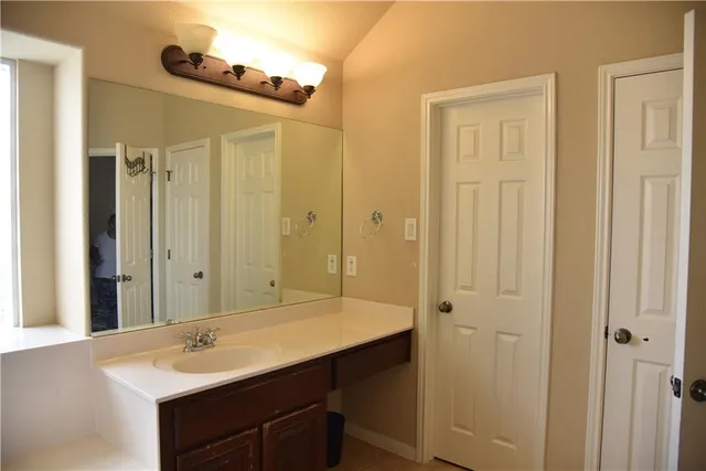 a bathroom with a sink and a mirror