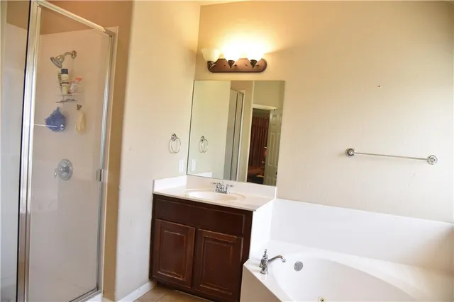 a bathroom with a tub sink and mirror