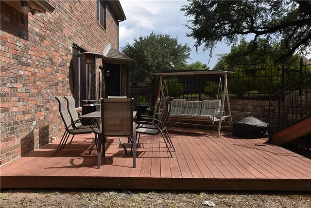 a view of patio with table and chairs and potted plants