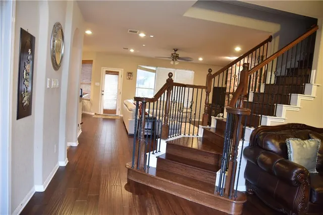 a view of entryway and hall with wooden floor