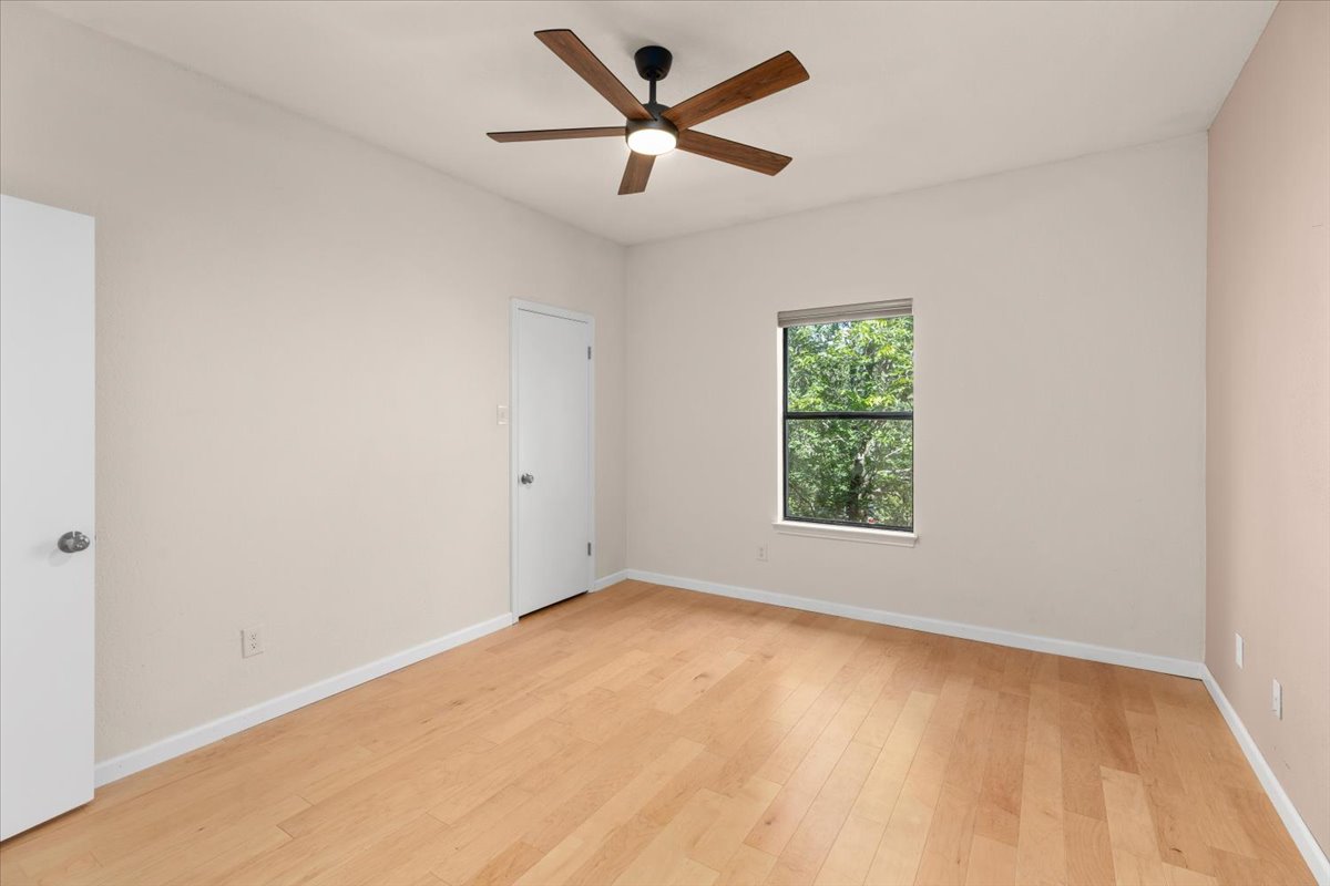 4711 Spicewood Springs Road, Unit 4222 Austin, TX 78759 - Photo 19 of 35 Light wood flooring and an elegant ceiling fan elevate this restful space.