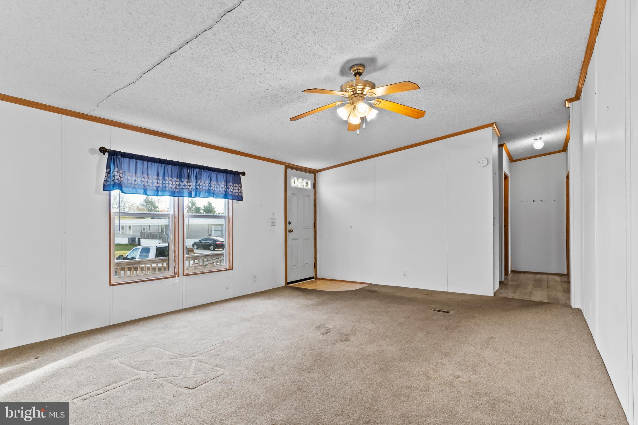 21 Hidden Noll Road Carlisle, PA 17013 - Photo 3 of 25 an empty room with windows and chandelier fan