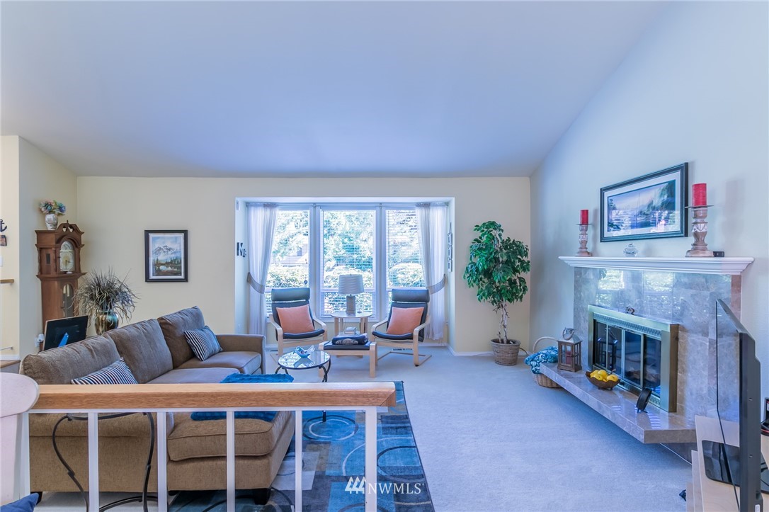 15612 Southeast 178th Street Renton, WA 98058 - Photo 20 of 40 a living room with furniture a fireplace and a table