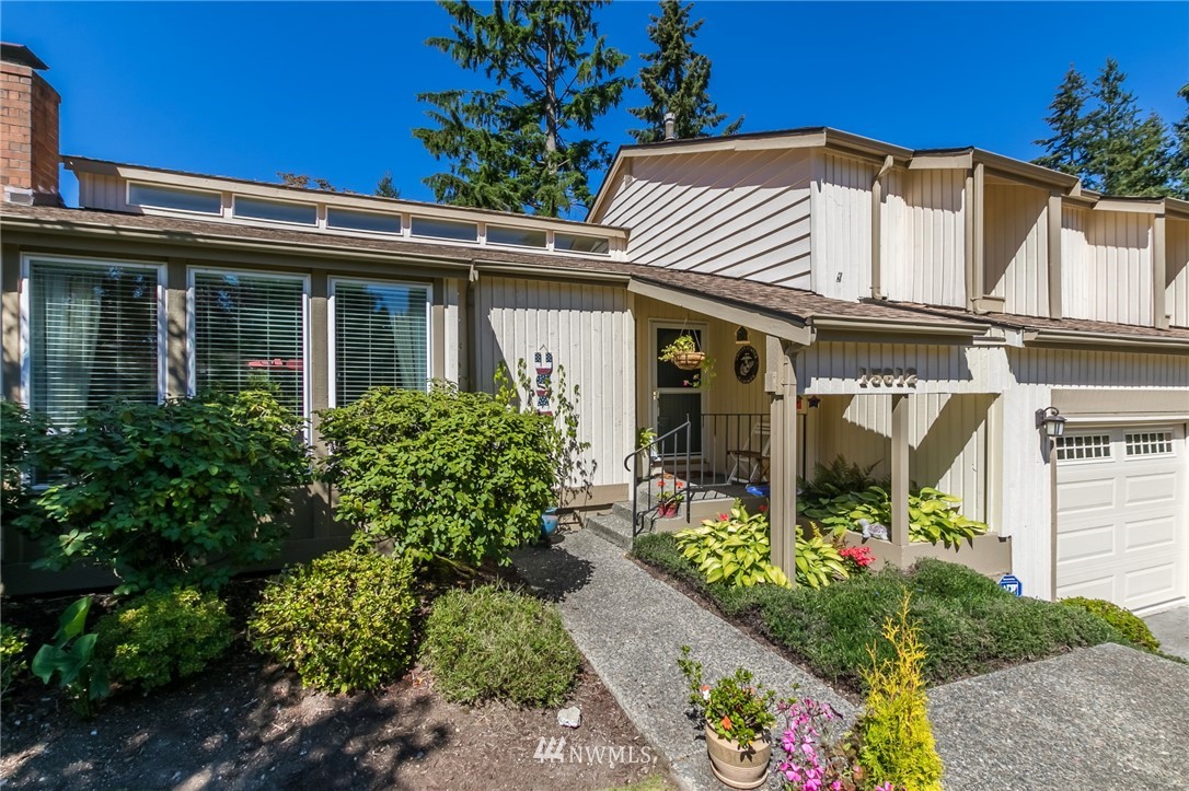 15612 Southeast 178th Street Renton, WA 98058 - Photo 3 of 40 a view of a house with large windows and flower plants