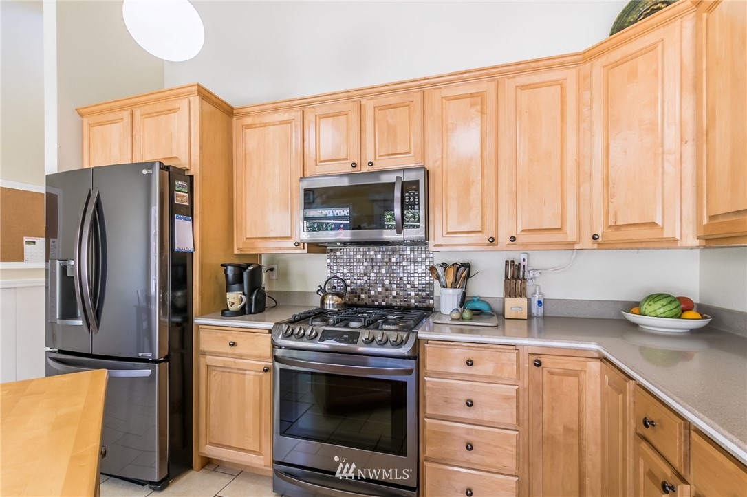 15612 Southeast 178th Street Renton, WA 98058 - Photo 23 of 40 a kitchen with stainless steel appliances a stove microwave and refrigerator