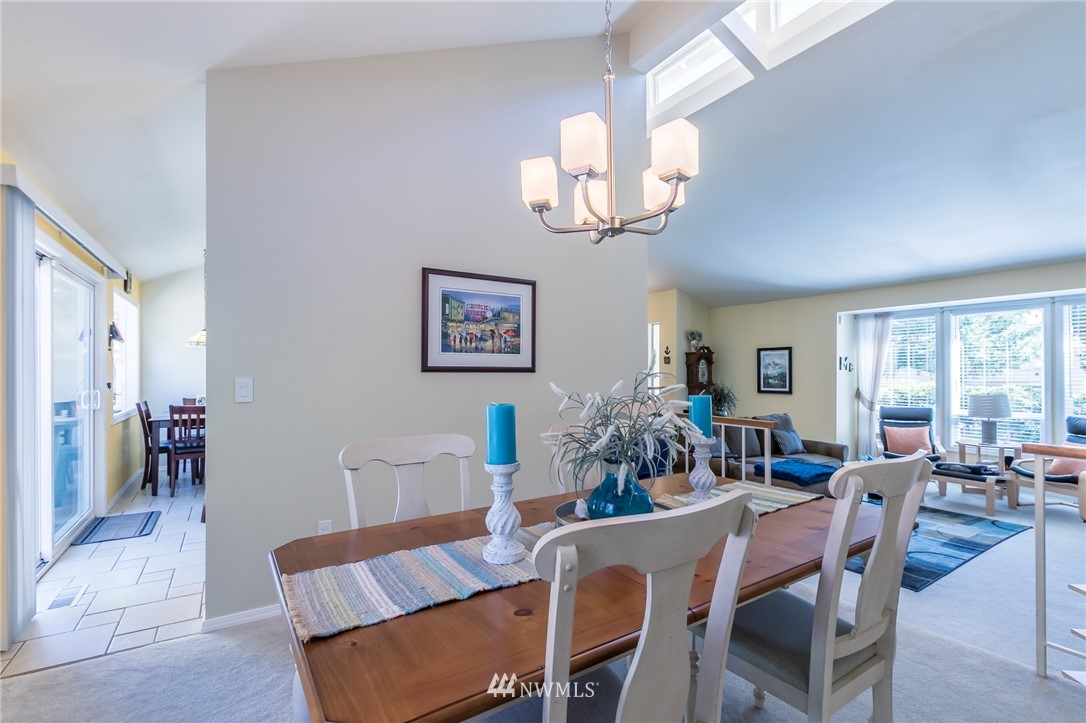 15612 Southeast 178th Street Renton, WA 98058 - Photo 27 of 40 a view of a dining room with furniture a chandelier and wooden floor