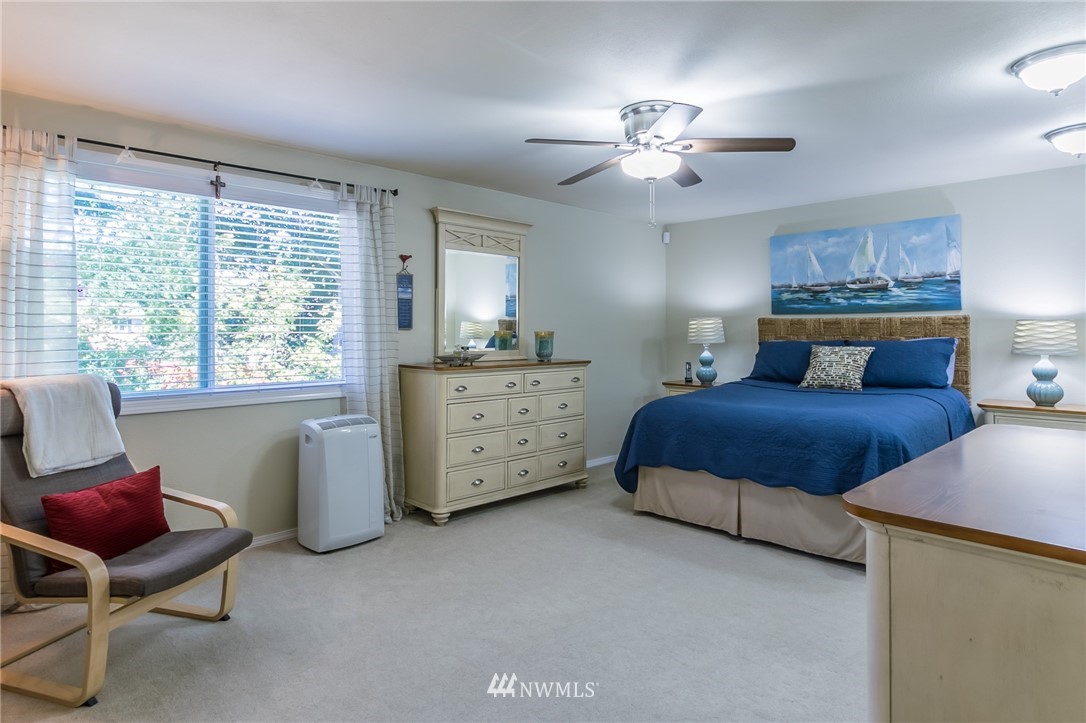 15612 Southeast 178th Street Renton, WA 98058 - Photo 29 of 40 a bedroom with a bed and a chandelier