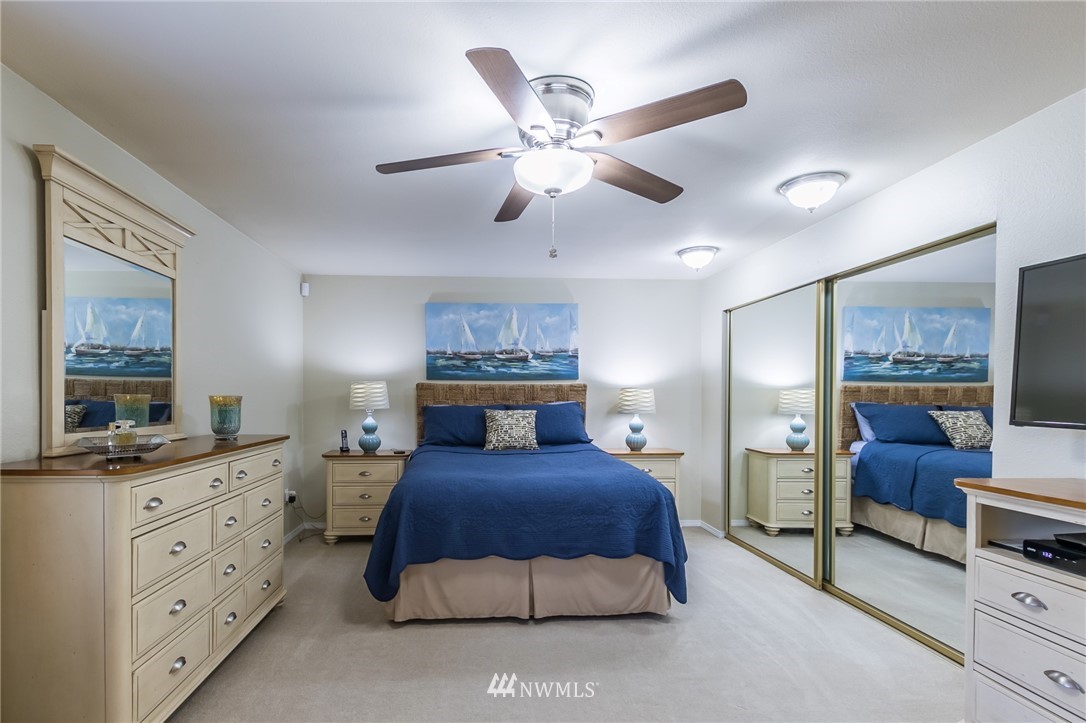 15612 Southeast 178th Street Renton, WA 98058 - Photo 30 of 40 a bedroom with a bed and a chandelier