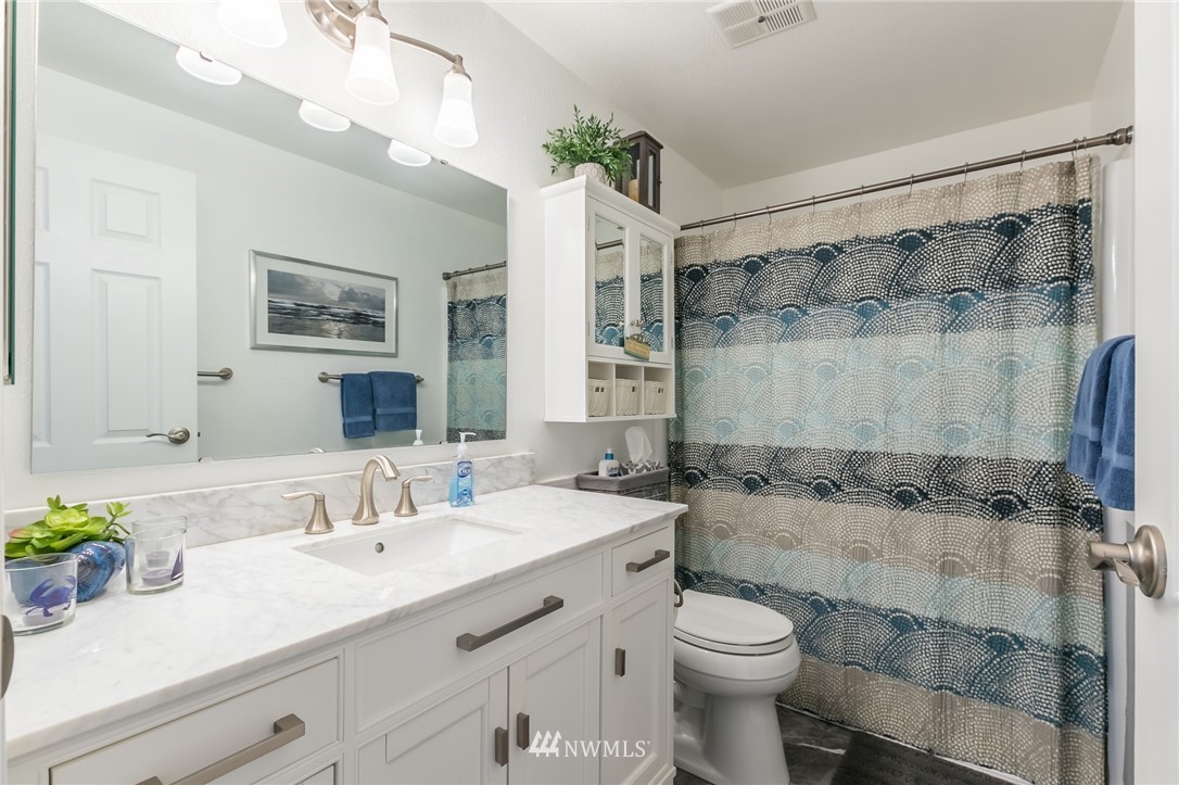 15612 Southeast 178th Street Renton, WA 98058 - Photo 34 of 40 a bathroom with a sink a toilet and shower