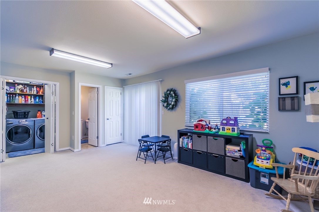 15612 Southeast 178th Street Renton, WA 98058 - Photo 37 of 40 a livingroom with furniture and a fireplace